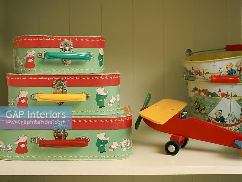 Bagage enfant et avion jouet sur étagère en bois