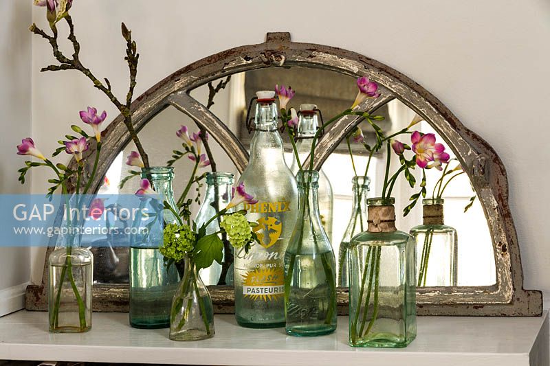 Fleurs de freesia dans des bouteilles vintage
