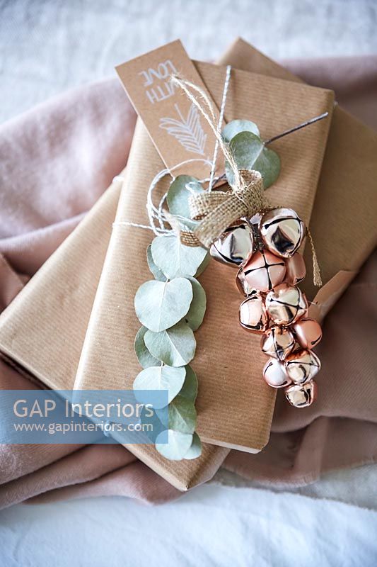 Cadeaux emballés dans du papier brun avec des clochettes décoratives