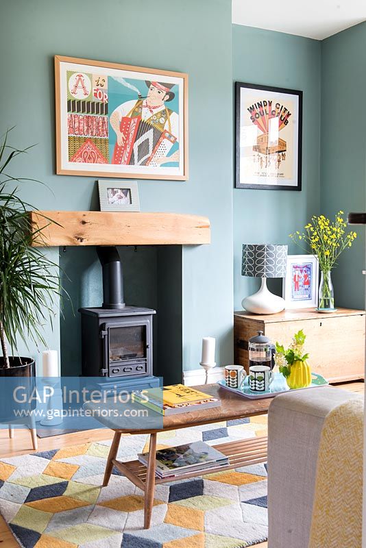 Poêle à bois dans un salon moderne avec des murs peints en turquoise