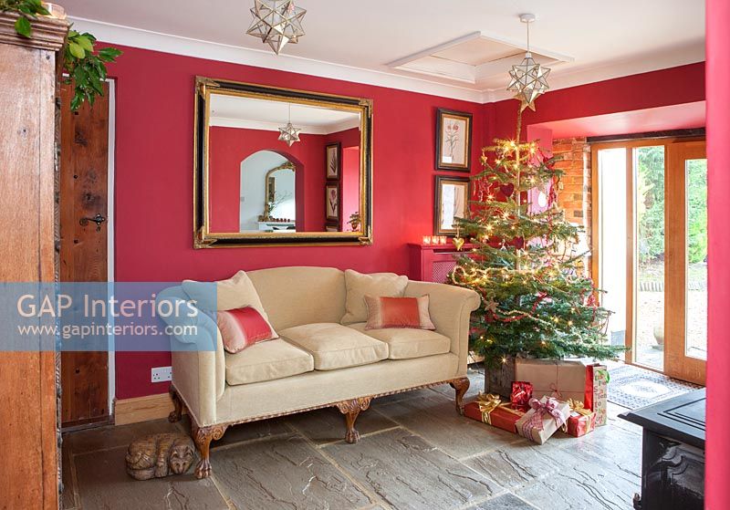 Salon de campagne peint en rouge décoré pour Noël