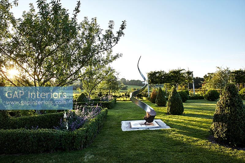 Jardin de campagne avec sculpture