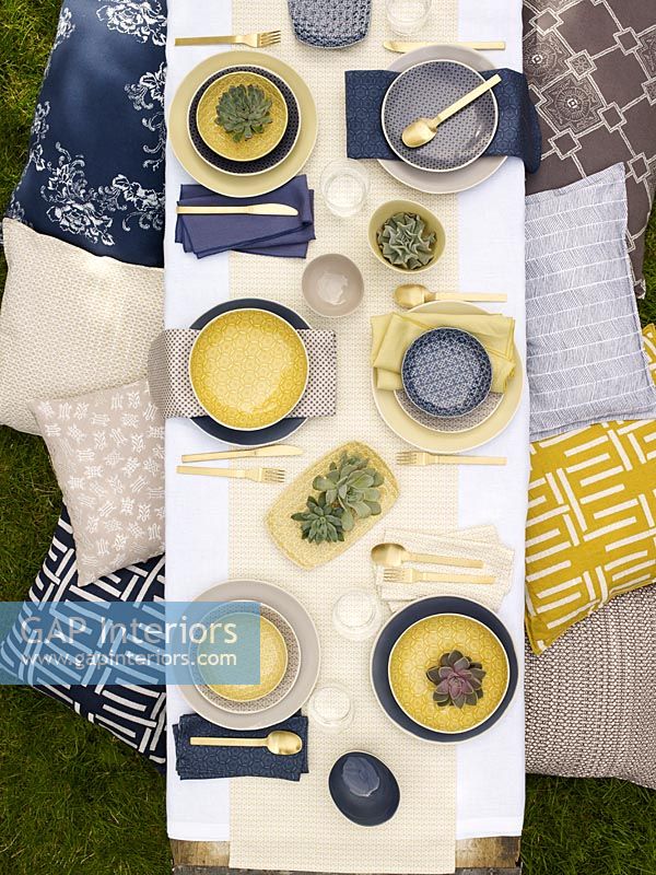 Vue aérienne de la table à manger d'extérieur avec des accessoires bleus et jaunes