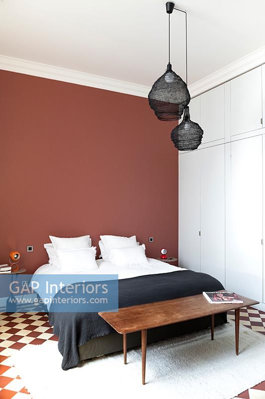 Chambre moderne avec mur rouge et sol en damier