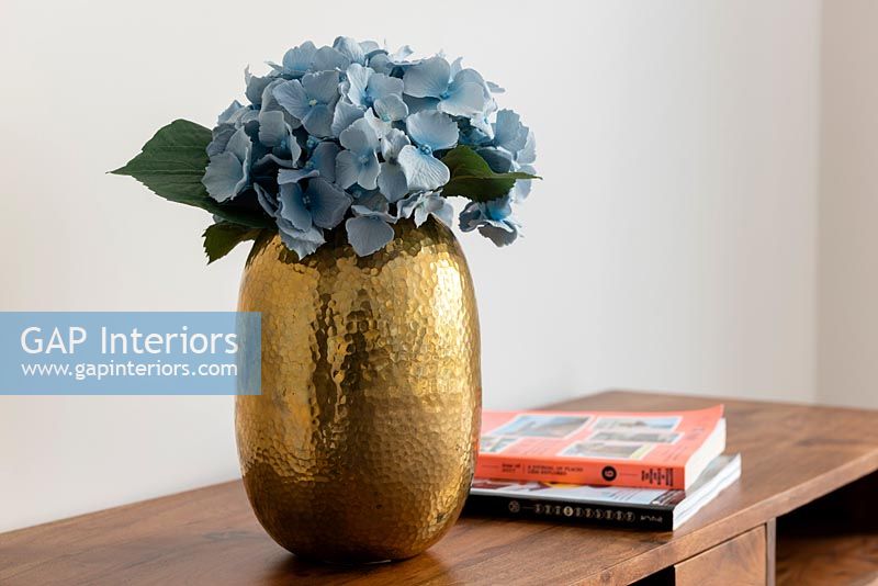Fleur d'hortensia bleue coupée dans un vase d'or