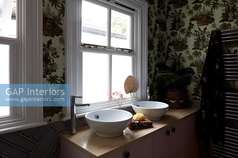 Papier peint à motifs et double vasque dans salle de bain moderne
