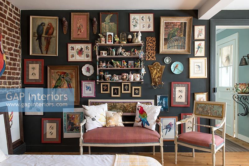 Chambre éclectique avec mur affichant des peintures et des ornements