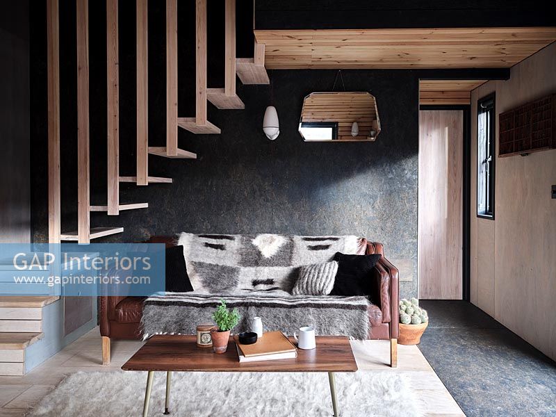 Salon moderne avec escalier en bois au-dessus d'un coin salon