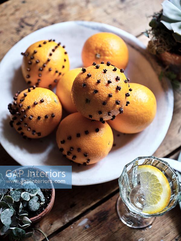 Pomanders orange et clou de girofle sur table - détail