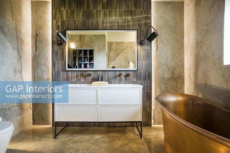 Mur caractéristique avec double vasque et baignoire en cuivre dans la salle de bain classique