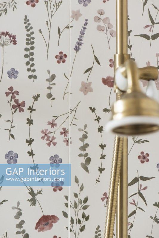 Floral wall and gold shower head in feminine bathroom - detail 