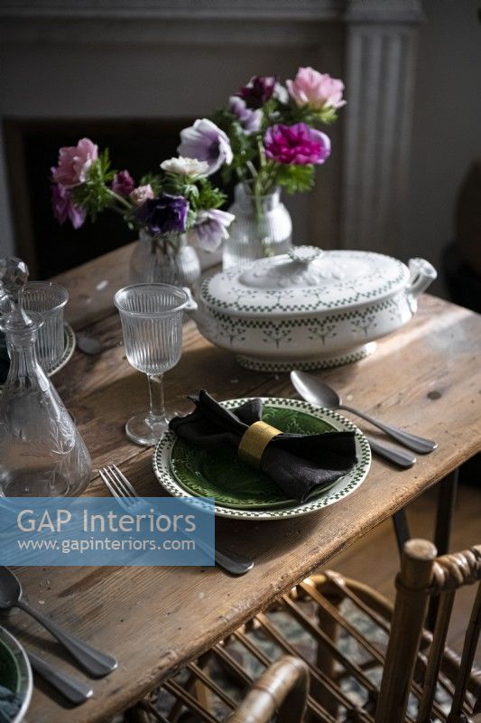 Detail of vintage crockery on wooden dining table