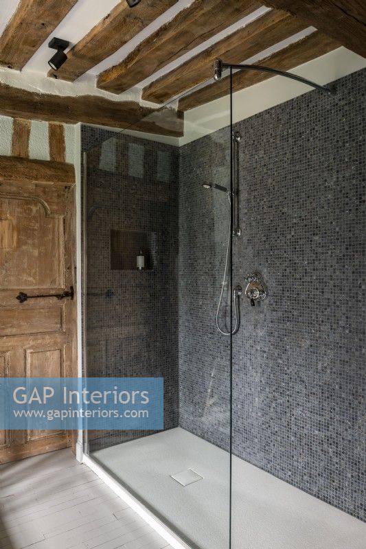 Carrelage en mosaïque grise dans une cabine de douche moderne