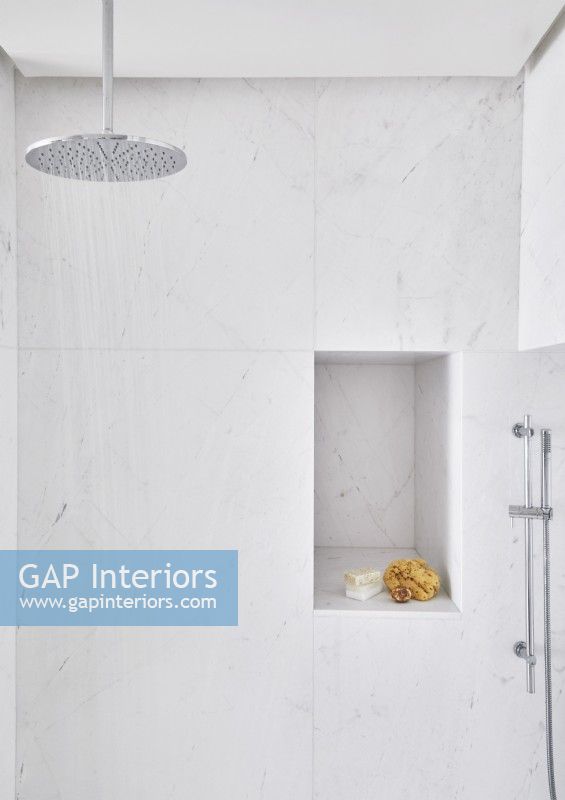 Cabine de douche en marbre blanc avec étagère en alcôve