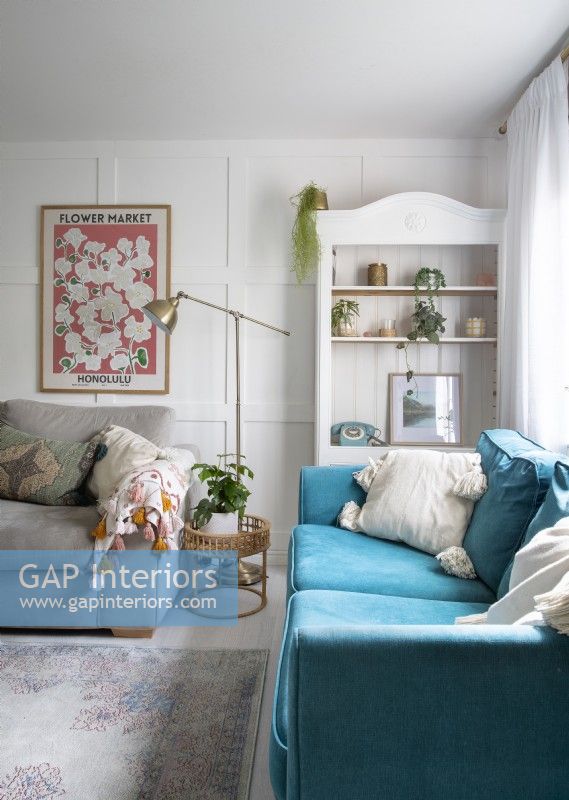 Canapé turquoise et étagère peinte en blanc dans un salon de campagne