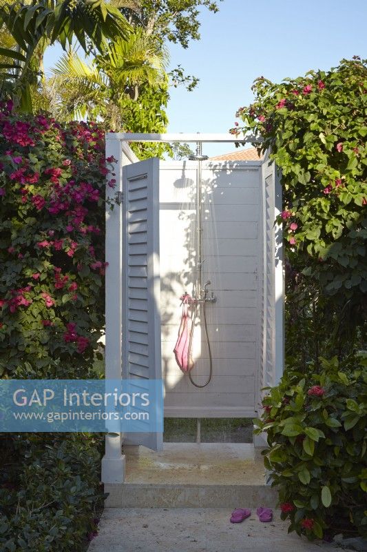 A tropical outdoor shower with bougainvillea