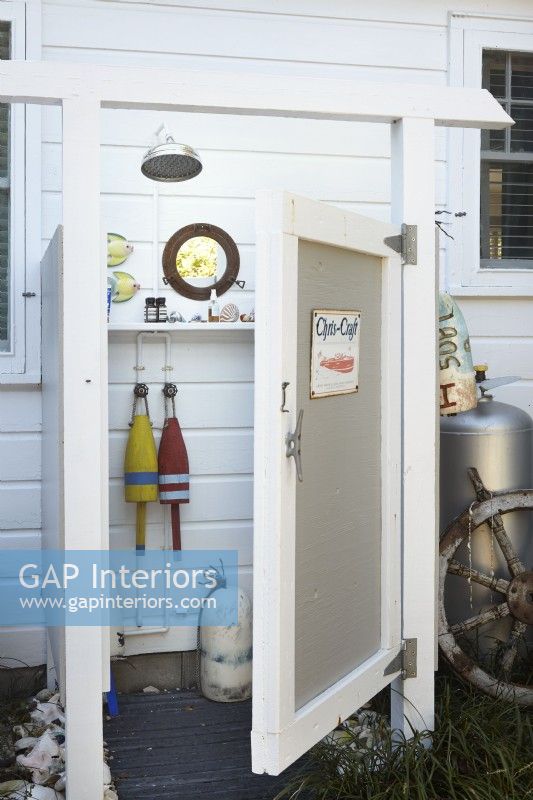 An outdoor shower with vintage beach, flea market style