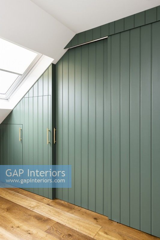 Built in wardrobes with green panelling.