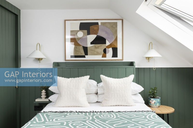 Loft bedroom makeover with green panelling.