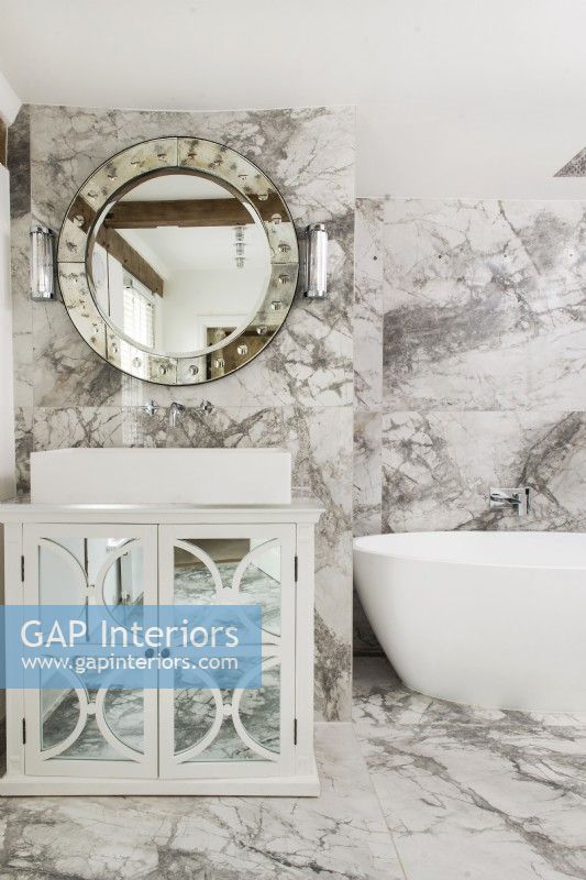 White and grey marble bathroom with mirrored cabinet