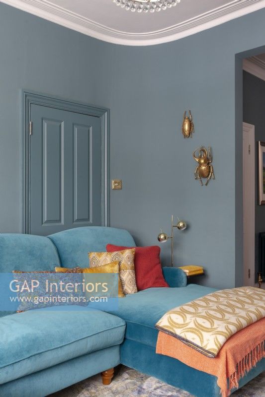 Bold blue sitting room with blue velvet sofa