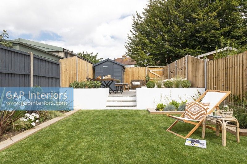 contemporary garden with painted grey fences