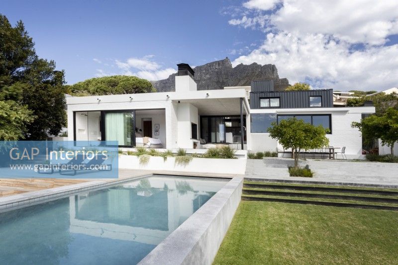 Swimming pool and lawned area backing contemporary house