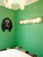 Chambre moderne avec des chaussures exposées et des murs peints en vert