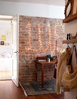 Couloir moderne avec guirlande lumineuse sur mur de briques apparentes