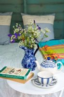 Tasse à thé et livres sur la table d'appoint