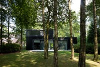 Maison contemporaine et jardin boisé