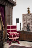 Un coin de la grande salle avec une copie d'une chaise victorienne et un coffre en bois du 17e siècle derrière