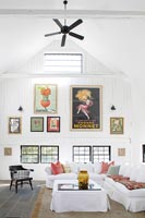 Affichage d'œuvres d'art colorées et ventilateur de plafond dans le salon de campagne moderne