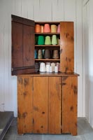 Armoire en bois vintage remplie de bobines de fil colorées