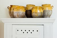 Collection de pots en céramique sur le dessus de l'armoire