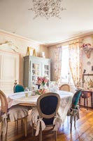 Salle à manger classique avec rideaux fleuris et détails d'époque