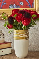 Arrangement de floraison de roses rouges dans un vase d'or