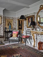 Salon classique avec papier peint à motifs et meubles anciens