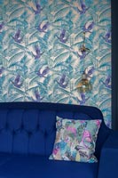 Papier peint sur mur de fonction derrière un canapé bleu dans un salon moderne