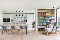 Cuisine-salle à manger moderne avec étagères et chaise de lecture dans le coin