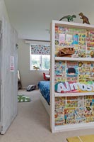 Bibliothèque bordée de pages de bandes dessinées pour enfants colorés dans la chambre des enfants