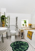 Salle de bain blanche moderne avec accessoires verts et jaunes
