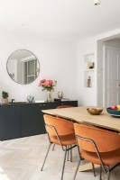 Salle à manger moderne avec des chaises orange en velours du milieu du siècle