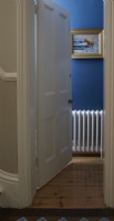 Par une porte dans un vestiaire peint en bleu montrant un radiateur blanc