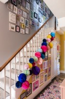 Murs de la galerie autour d'un escalier décoré de pompons en papier colorés