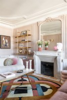 Cheminée et murs peints en rose dans un salon moderne