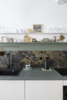 Détail du plan de travail en béton de la cuisine moderne et du dosseret en marbre