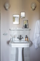 Lavabo de style classique dans la salle de bain avec trois miroirs sur le mur au-dessus