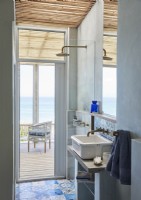 Petite cabine de douche avec porte sur terrasse et vue mer