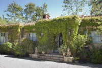 L'extérieur de la maison fait un clin d'œil à l'architecture méditerranéenne traditionnelle. Son aspect pittoresque est obtenu en teintant le plâtre avec des pigments naturels d'ocre rose de France et des murs drapés de vigne.